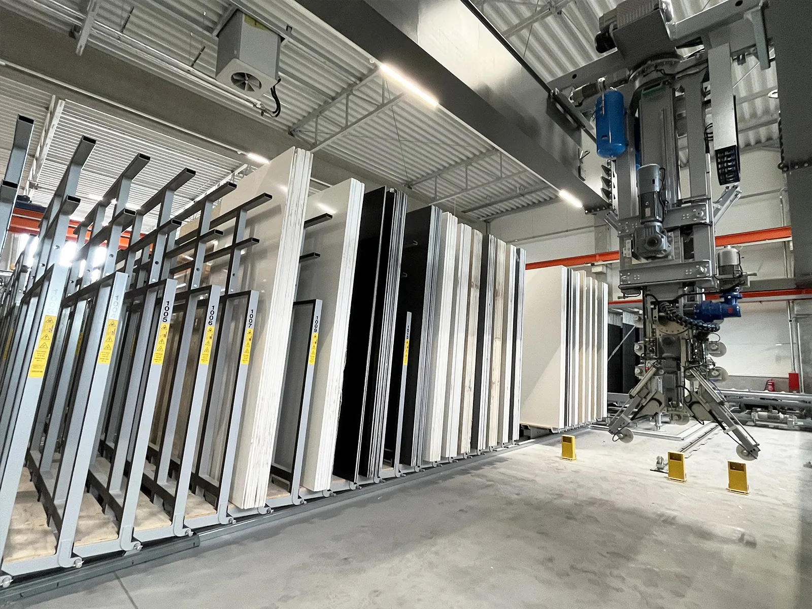 Poland, 2026 — Two multi-axis cranes feeding an automated cutting and edge-polishing line